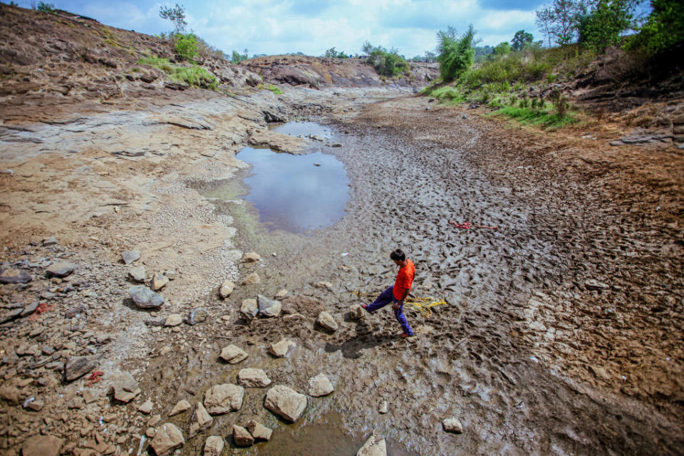 a man walking in a barren land