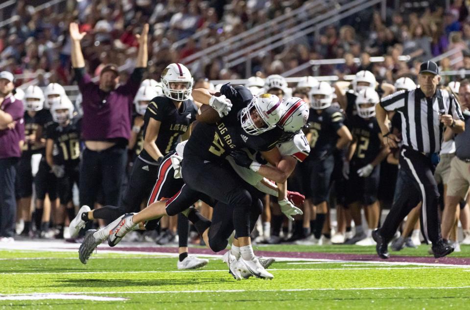 McDonald County defender Sam Barton tackles Wildcat WR Logan Cook at Logan-Rogersville on September 9, 2022.