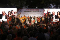 Rui Rio, leader of the Social Democratic Party, center, gestures during an election campaign rally in Lisbon Friday, Oct. 4, 2019. Portugal will hold a general election on Oct. 6 in which voters will choose members of the next Portuguese parliament. Slogan in the background reads, "Commitment, Portugal First". (AP Photo/Armando Franca)