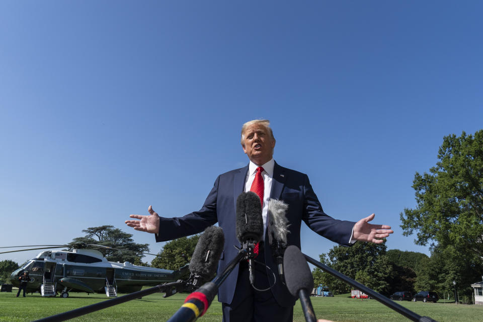 President Donald Trump speaks with reporters as he walks to Marine One on the South Lawn of the White House, Monday, Aug. 17, 2020, in Washington. Trump is en route to Minnesota and Wisconsin. (AP Photo/Alex Brandon)