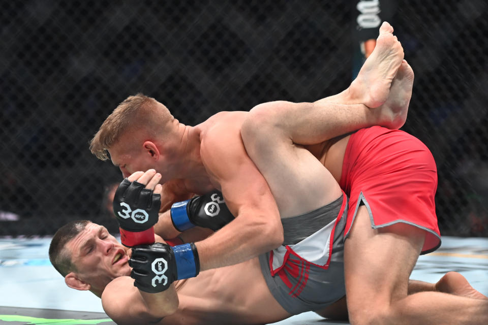 Aug 19, 2023; Boston, MA, USA; Kurt Holobaugh (red gloves) fights Austin Hubbard (blue gloves) during UFC 292 at TD Garden. Mandatory Credit: Bob DeChiara-USA TODAY Sports