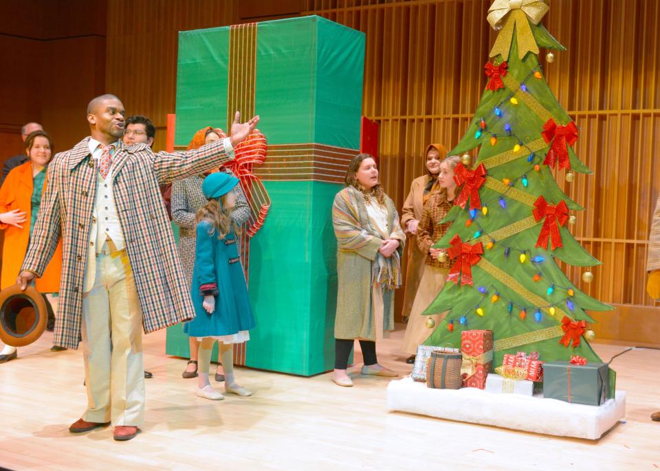 As the mayor, William Powell leads the townspeople lighting the Christmas tree in the town square during Act 1 of "The Gift," an opera written by local composer Paul Herman that South Bend Lyric Opera presents Jan. 27 and 28 at Indiana University South Bend’s Northside Hall.