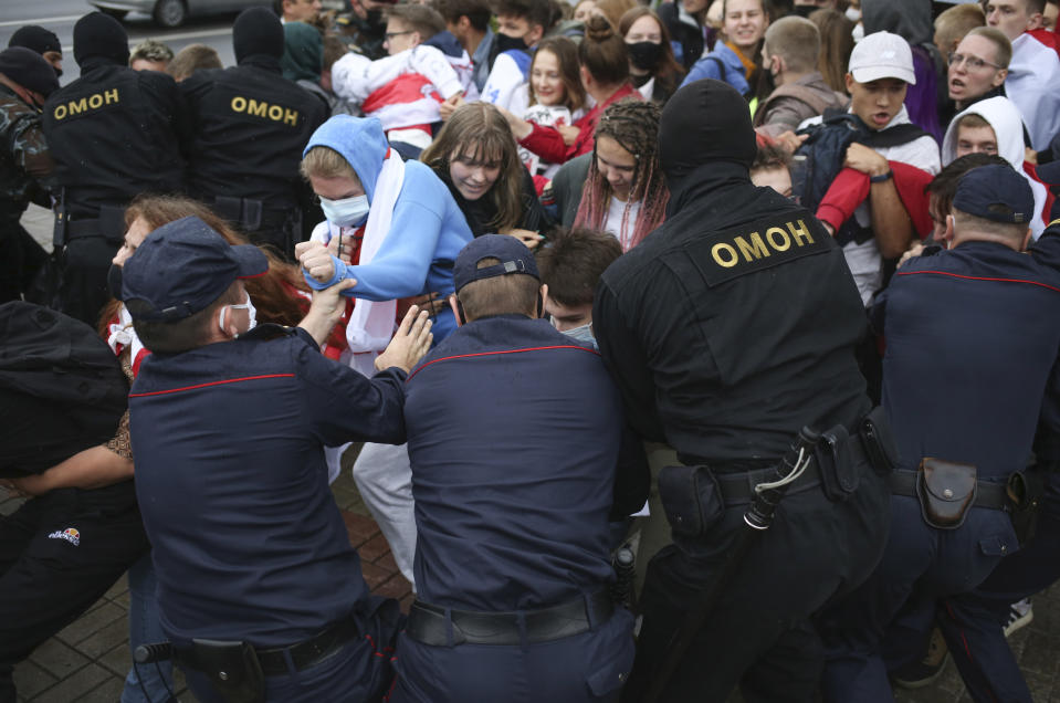 Police detain students during a protest in Minsk, Belarus, Tuesday, Sept. 1, 2020. Several hundred students on Tuesday gathered in Minsk and marched through the city center, demanding the resignation of the country's authoritarian leader after an election the opposition denounced as rigged. Many have been detained as police moved to break up the crowds. (Tut.By via AP)