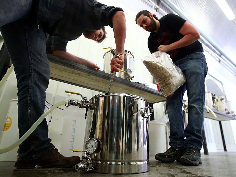 UBREW co-founder Matthew Denham (L) and operational manager Nick Fletcher, demonstrate the brewing process at their open brewery on February 16, 2015 in London, England. UBREW, opened by co-founders Matthew Denham and Wilf Horsfall, is an open brewery where members can brew their own beers with professional equipment amongst a community of like-minded beer lovers. (Photo by )
