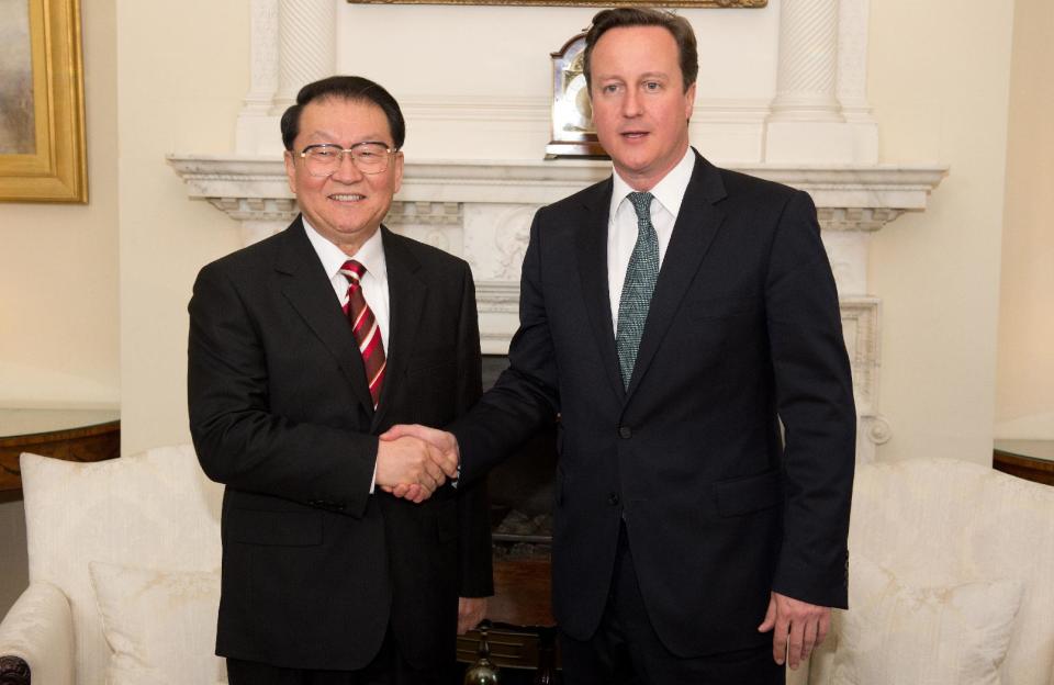 Chinese Communist Party official Li Changchun, left, shakes hands with British Prime Minister David Cameron during their meeting at Downing Street in central London on Tuesday April 17, 2012. (AP Photo/Leon Neal. Pool)