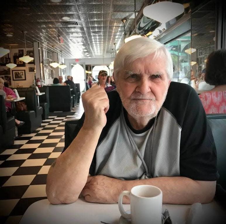 Raymond Barber of St. Cloud, Fla., sitting in a restaurant in 2021. He died of COVID.