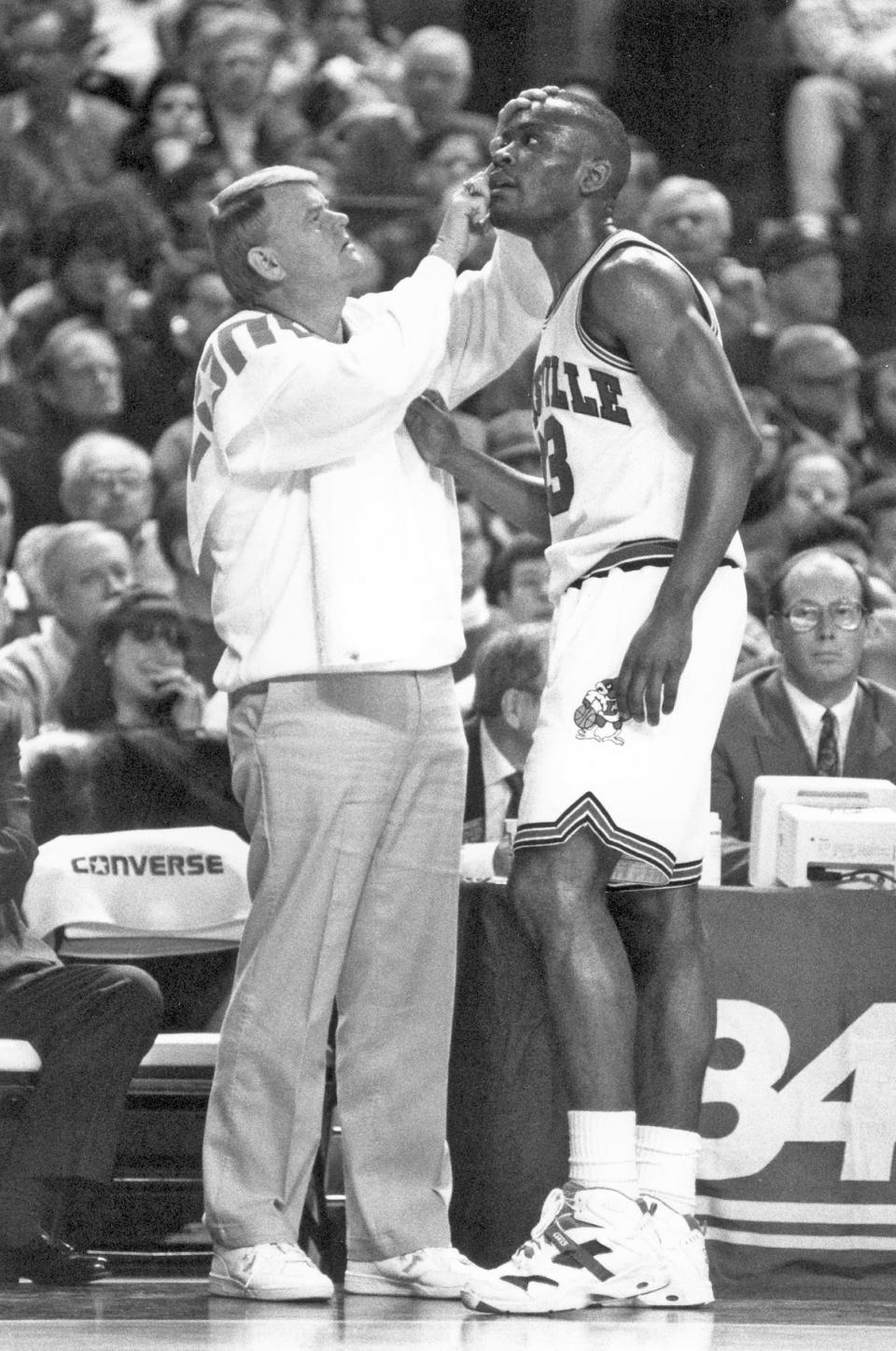 Jerry May, left, the longtime assistant athletic director for sports medicine at the University of Louisville, tends to Greg Minor during a men's basketball game in the early 1990s. May died Sunday at age 72.