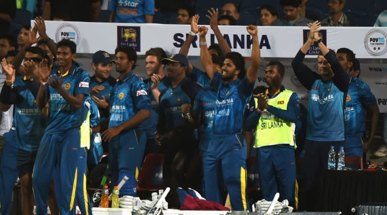 Sri Lankan cricketers celebrate after winning the first T20 international match against India at the MCA International Cricket Stadium in Pune on February 9, 2016