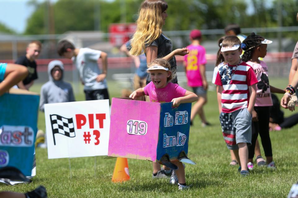 Mayflower Mill Elementary School kindergarteners run around Mayflower Mill Elementary School's Kindy 500 course set up in McCutcheon High School’s soccer field, on Monday, May 22, 2023, in Lafayette, Indiana.