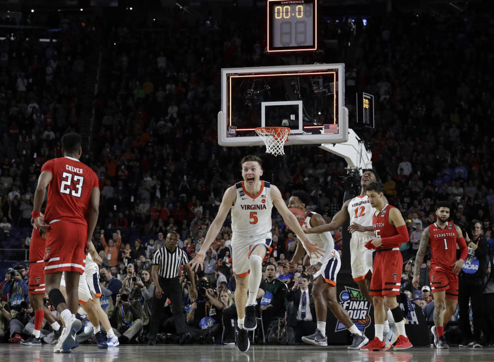 Virginia's Kyle Guy (5) and his teammates celebrate after defeating Texas Tech 85-77 in the overtime in the championship of the Final Four NCAA college basketball tournament, Monday, April 8, 2019, in Minneapolis. (AP Photo/David J. Phillip)