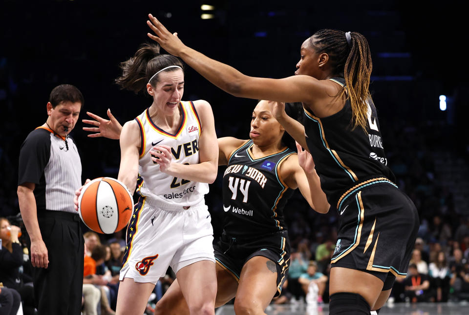 New York Liberty forwards Betnijah Laney-Hamilton (44) and Kennedy Burke (2) defend against Indiana Fever guard Caitlin Clark (22) during the first half of a WNBA basketball game, Saturday, May 18, 2024, in New York. (AP Photo/Noah K. Murray)
