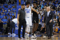 UCLA guard Jaime Jaquez Jr. (24) leaves the court with an injury after he was fouled by Colorado forward Jabari Walker (12) during the first half of an NCAA college basketball game in Los Angeles, Wednesday, Dec. 1, 2021. (AP Photo/Ashley Landis)