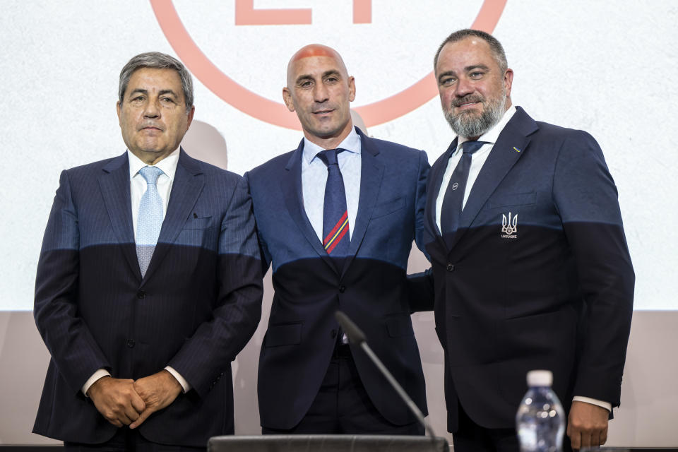 Portuguese Soccer Federation President Fernando Gomes, left, President of the Spanish Royal Federation of Soccer (RFEF), Luis Rubiales, center, Ukrainian Football Federation President Andriy Pavelko, right, stand together during a press conference about the announcing that Ukraine is joining Spain and Portugal in their joint bid to host the World Cup in 2030, at the UEFA Headquarters, in Nyon, Switzerland, Wednesday, October 5, 2022. The proposal harnesses the idea that football can restore hope and peace, while Ukraine has been at war with Russia for months. (Martial Trezzini/Keystone via AP)