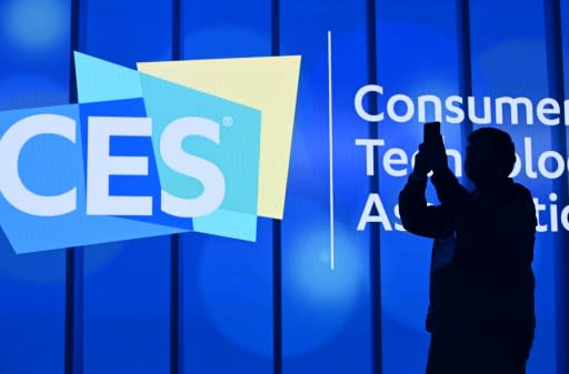 An attendee photographs a sign next to the CES logo ahead of the first keynote address at the 2020 Consumer Electronics Show in Las Vegas, Nevada