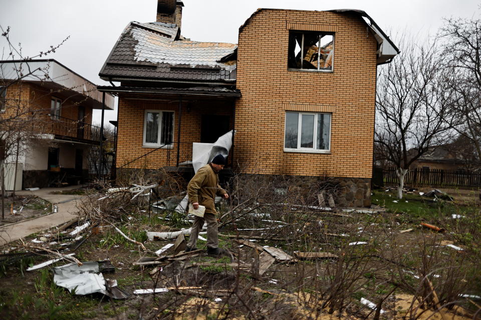 Vitalii Zhyvotovskyi, 50, walks outside his house that he told Reuters was destroyed by Russian troops as they were retreating from Bucha, in Bucha, Kyiv region, Ukraine April 19, 2022. Picture taken April 19, 2022.  To match Special Report UKRAINE-CRISIS/BUCHA-KILLINGS-SOLDIERS    REUTERS/Zohra Bensemra