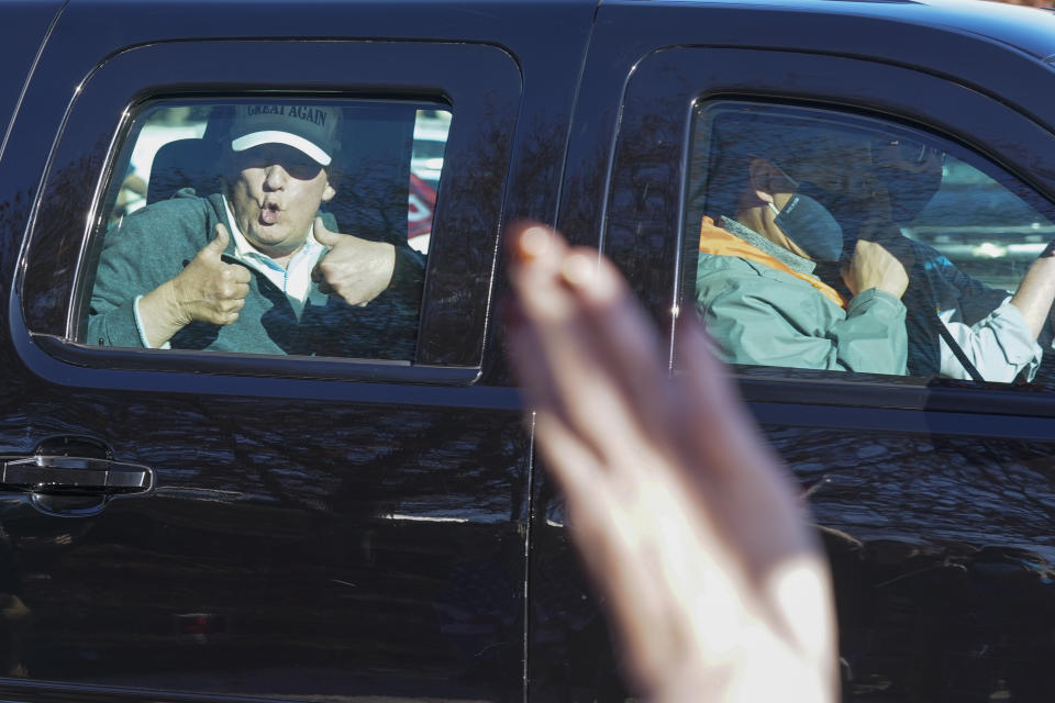 President Donald Trump gives two thumbs up to supporters as he departs after playing golf at the Trump National Golf Club in Sterling Va., Sunday Nov. 8, 2020. (AP Photo/Steve Helber)