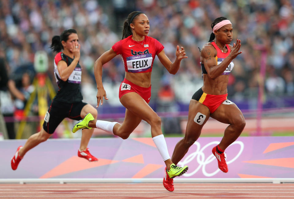 <a href="http://sports.yahoo.com/olympics/track-field/allyson-felix-1132858" data-ylk="slk:Allyson Felix;elm:context_link;itc:0;sec:content-canvas" class="link ">Allyson Felix</a> of the United States and Toea Wisil of Papua New Guinea competes in the Women's 100m Round 1 Heats on Day 7 of the London 2012 Olympic Games at Olympic Stadium on August 3, 2012 in London, England.