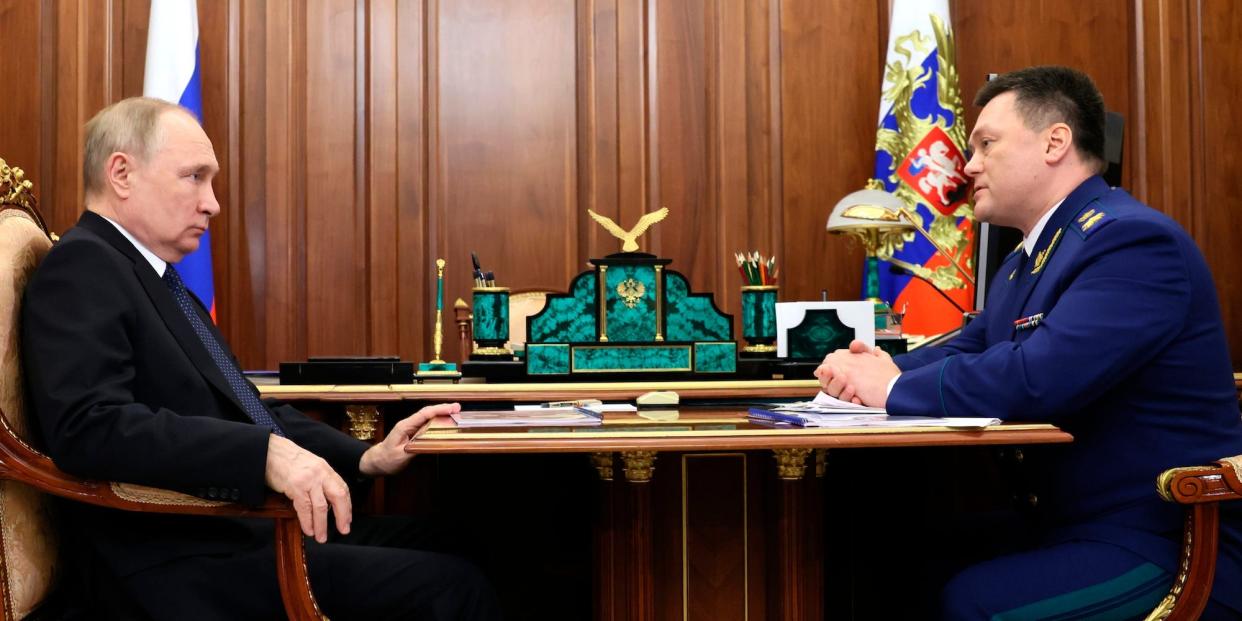 Russian President Vladimir Putin listens to Russian Prosecutor General Igor Krasnov at the Kremlin in Moscow, Russia, Tuesday, Jan. 31, 2023.
