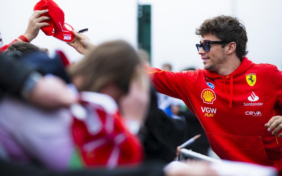 Charles Leclerc of Monaco and Ferrari signs autographs for fans at the fan stage prior to practice ahead of the F1 Grand Prix of Great Britain at Silverstone Circuit on July 05, 2024 in Northampton, England