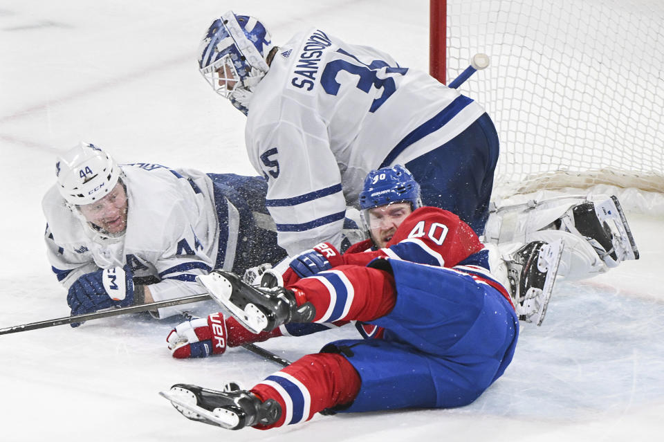 Toronto Maple Leafs' Morgan Rielly (44) and Montreal Canadiens' Joel Armia (40) collide with Leafs goalie Ilya Samsonov during the second period of an NHL hockey game Saturday, March 9, 2024, in Montreal. (Graham Hughes/The Canadian Press via AP)