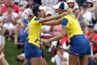 Aug 19, 2017; West Des Moines, IA, USA; Europe golfer Georgia Hall hugs Anna Nordqvist after they win their match over the USA on the 17th hole during the second round morning session during The Solheim Cup international golf tournament at Des Moines Golf and Country Club. Mandatory Credit: Brian Spurlock-USA TODAY Sports