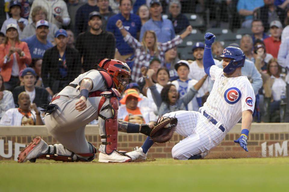 St. Louis Cardinals catcher Yadier Molina, left, tags out Chicago Cubs' Patrick Wisdom at home during the sixth inning of a baseball game, Sunday, June 5, 2022, at Wrigley Field in Chicago. (AP Photo/Mark Black)