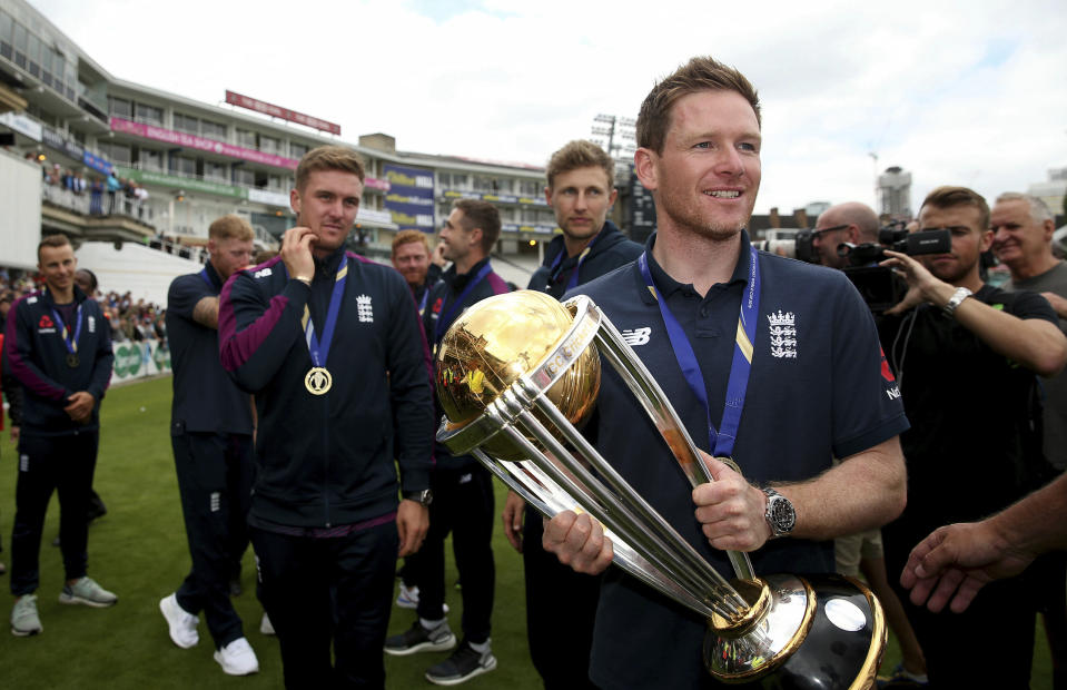 England's Eoin Morgan with the Trophy during celebrations marking their Cricket World Cup victory on Sunday over New Zealand, during at the Oval cricket ground in London Monday July 15, 2019. (Steven Paston/PA via AP)