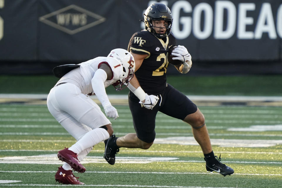 Wake Forest tight end Cameron Hite, right, runs as Elon defensive back Caleb Curtain defends during the first half of an NCAA college football game in Winston-Salem, N.C., Thursday, Aug. 31, 2023. (AP Photo/Chuck Burton)