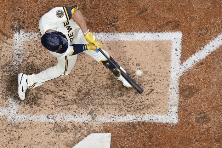 Milwaukee Brewers' Tyrone Taylor hits an RBI single during the seventh inning of a baseball game against the New York Mets Wednesday, Sept. 21, 2022, in Milwaukee. (AP Photo/Morry Gash)