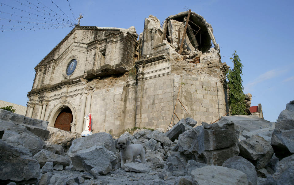 The damage of St. Catherine church, with its headless statue, is seen following a 6.1 magnitude earthquake that also caused the collapse of a commercial building in Porac township, Pampanga province, north of Manila, Philippines, Tuesday, April 23, 2019. The strong earthquake struck the northern Philippines Monday trapping some people in a collapsed building, damaged an airport terminal and knocked out power in at least one province, officials said. (AP Photo/Bullit Marquez)