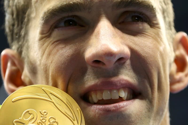 2016 Rio Olympics - Swimming - Victory Ceremony - Men's 200m Butterfly Victory Ceremony - Olympic Aquatics Stadium - Rio de Janeiro, Brazil - 09/08/2016. Michael Phelps (USA) of USA poses with his gold medal. REUTERS/Jeremy Lee