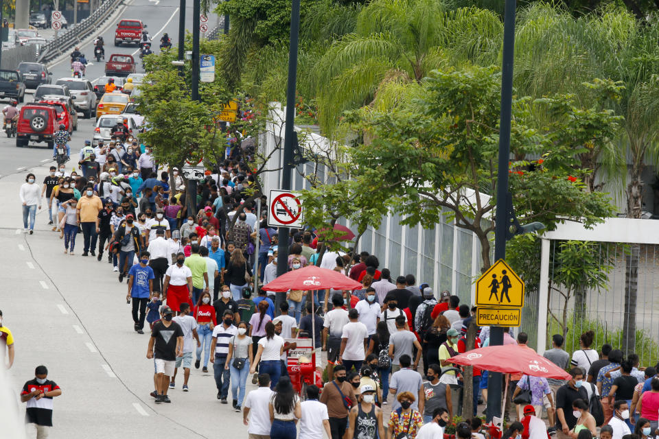 Voters line up at the Instituto Tecnológico Superior Simón Bolívar during general elections in Guayaquil, Ecuador, Sunday, Feb. 7, 2021. Amidst the new coronavirus pandemic Ecuadoreans went to the polls in a first round presidential and legislative election. (AP Photo/Angel Dejesus)