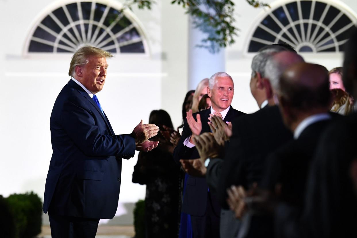 Donald Trump, alongside Vice President Mike Pence, arrives to listen to US First Lady Melania Trump address the Republican Convention during its second day from the Rose Garden of the White House: AFP via Getty Images