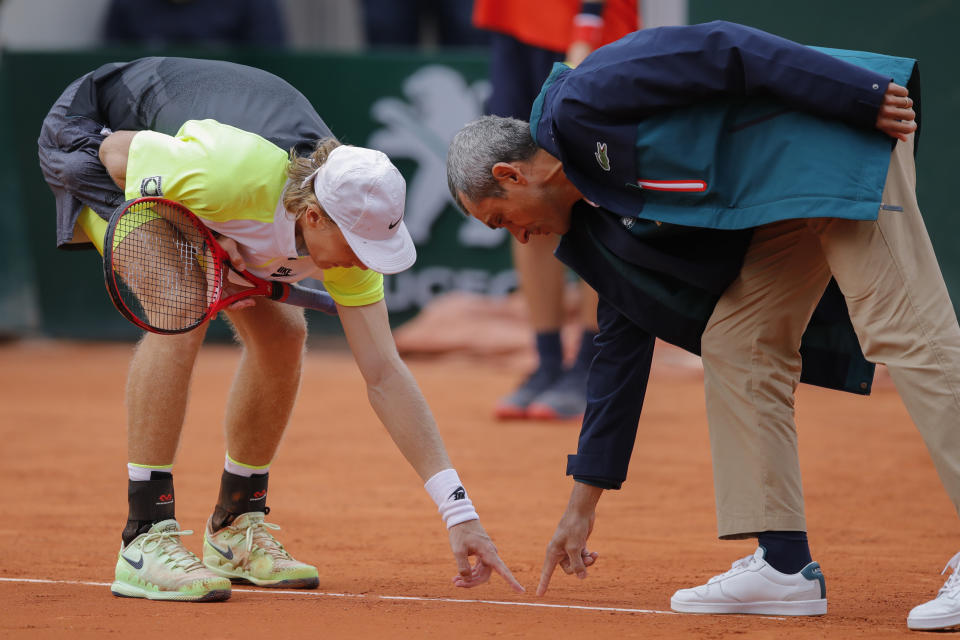Canada's Denis Shapovalov argues with the umpire over a line call in the second round match of the French Open tennis tournament against Spain's Roberto Carballes Baena at the Roland Garros stadium in Paris, France, Thursday, Oct. 1, 2020. (AP Photo/Christophe Ena)