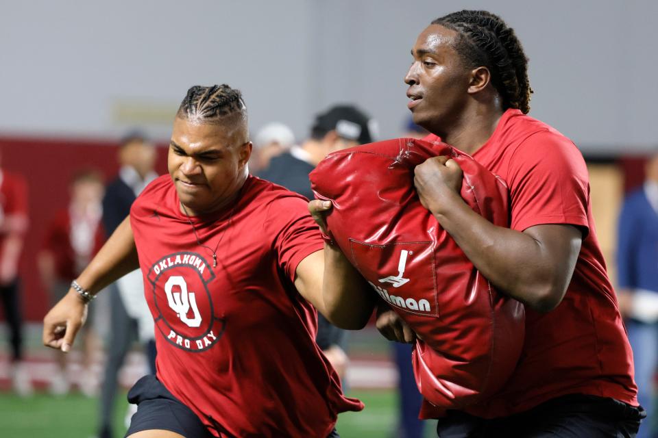 Oklahoma offensive lineman Walter Rousue, left, and Tyler Guyton run a drill during the University of Oklahoma (OU) Sooners Pro Day in Norman, Okla., Tuesday, March 12, 2024.
