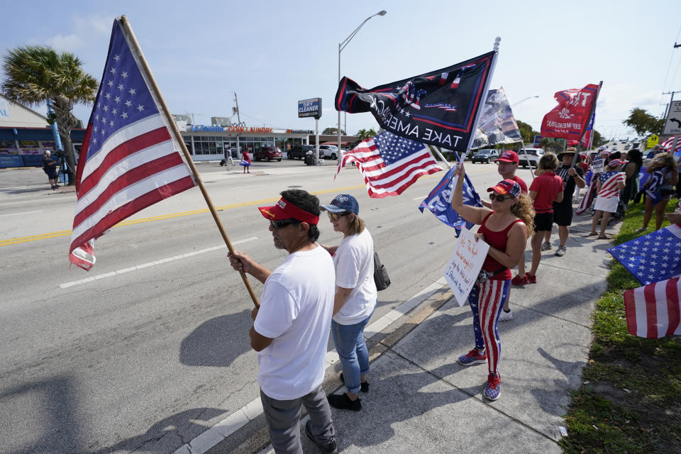 Supporters of former President Donald Trump wave flags and cheer at a rally, Monday, April 3, 2023, in West Palm Beach, Fla. (AP Photo/Wilfredo Lee)