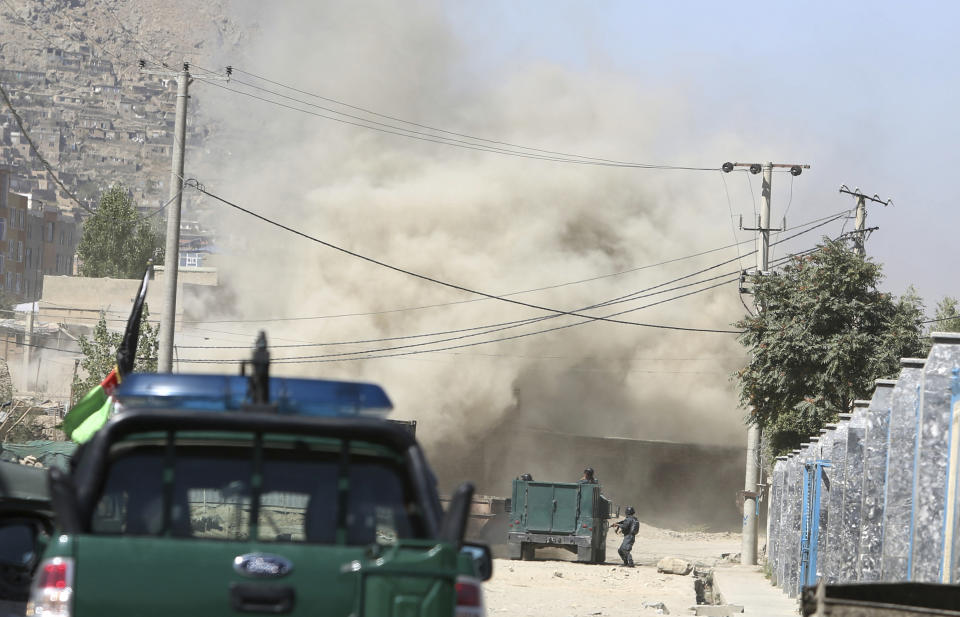 Smoke rises from a house where suspected attackers are hiding in Kabul, Afghanistan, Tuesday, Aug. 21, 2018. The Taliban fired rockets toward the presidential palace in Kabul Tuesday as President Ashraf Ghani was giving his holiday message for the Muslim celebrations of Eid al-Adha, said police official Jan Agha. (AP Photo/Rahmat Gul)