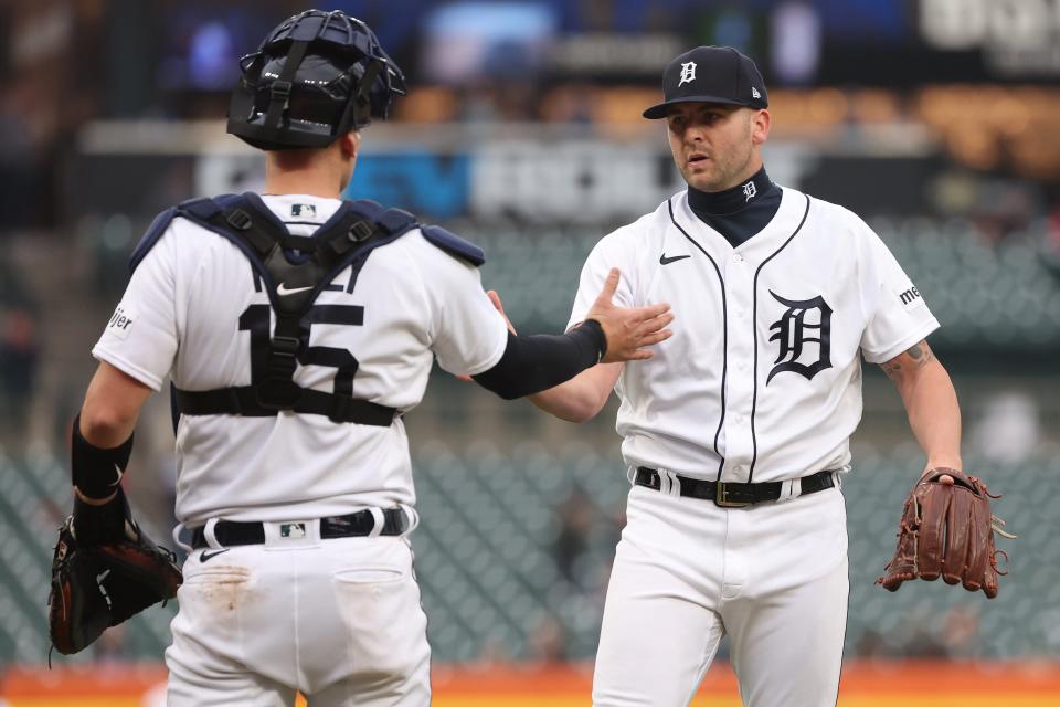 Alex Lange of the Detroit Tigers celebrates a 7-3 win over the Kansas City Royals with Carson Kelly at Comerica Park on September 28, 2023 in Detroit, Michigan.