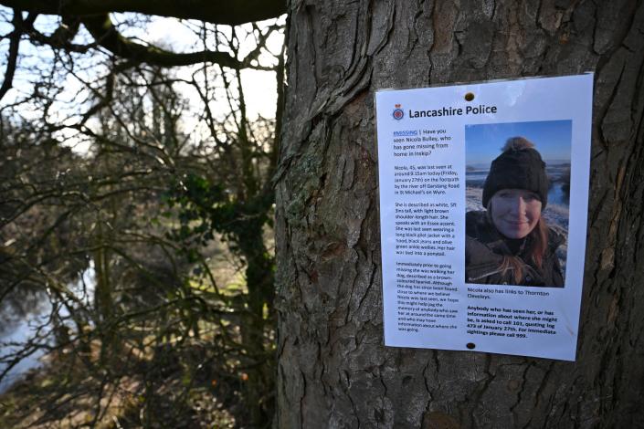A poster asking for information on missing Nicola &#39;Nikki&#39; Bulley is pictured on a tree close to where her phone and dog&#39;s harness were discovered, by the banks of the River Wyre, in St Michael&#39;s on Wyre, near Preston, north west England on February 6, 2023, as the search for her continues. - Specialist divers were on Monday scouring a river bed for traces of a missing woman, more than a week after she appeared to 