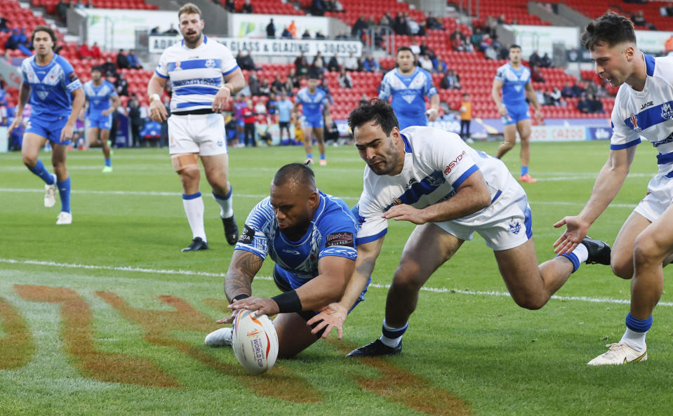 Samoa's Junior Paulo scores a try, during the Rugby League World Cup group A match between Samoa and Greece, at the Eco-Power Stadium, in Doncaster, England, Sunday, Oct. 23, 2022. (Richard Sellers/PA via AP)