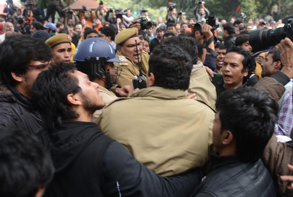 Indian protestors scuffle with police officials during a rally in New Delhi on December 30, 2012, following the cremation of a gangrape victim in the Indian capital. (RAVEENDRAN/AFP/Getty Images)