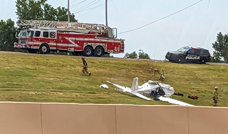 Emergency Crews work the scene of a small plane crash on Sunday near I-235 and I-44 in Oklahoma City.