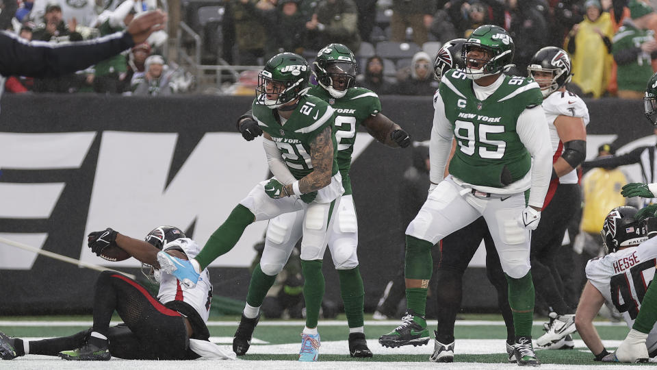 New York Jets defensive tackle Quinnen Williams (95), safety Ashtyn Davis (21) and defensive end Micheal Clemons (72) celebrate after taking down Atlanta Falcons running back Bijan Robinson (7) in the end zone for a safety during the first quarter of an NFL football game, Sunday, Dec. 3, 2023, in East Rutherford, N.J. (AP Photo/Adam Hunger)