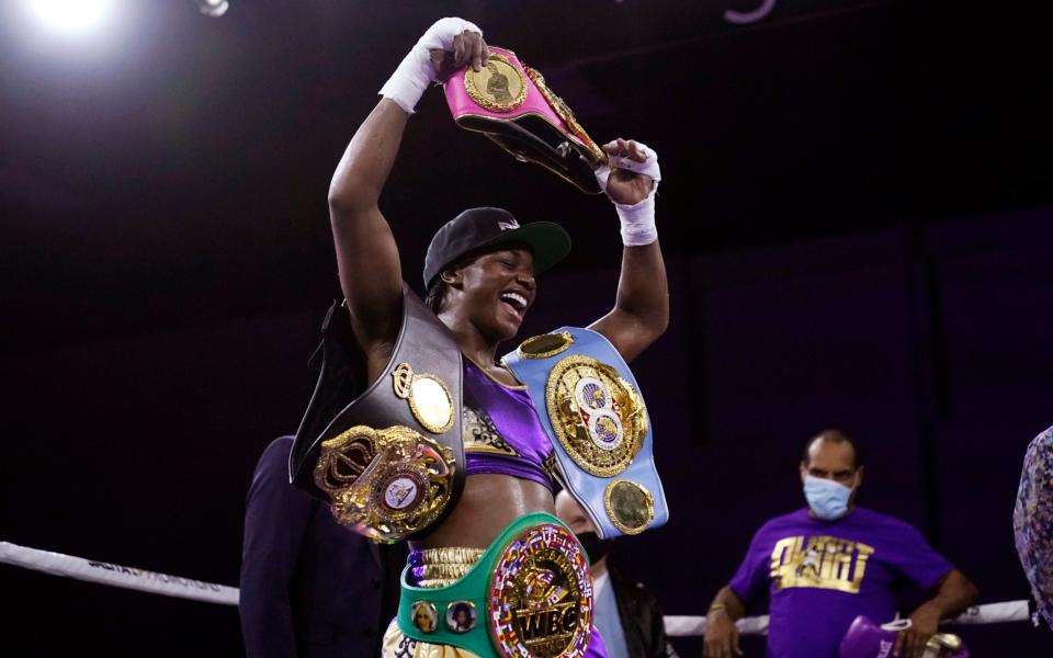 Claressa Shields holds her championship belts after defeating Marie-Eve Dicaire - AP