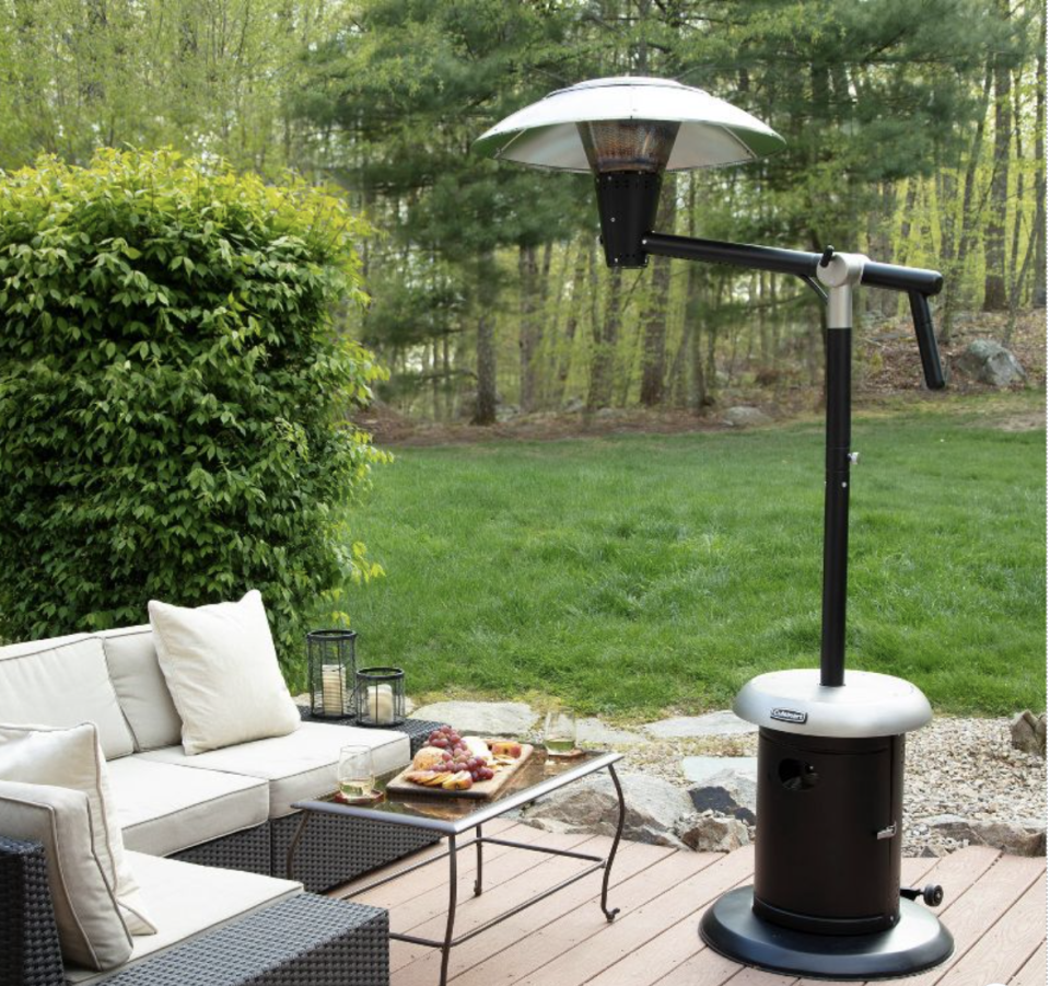 Cuisinart Perfect Position Outdoor Patio Heater sitting outside in a yard with grass and greenery in the background