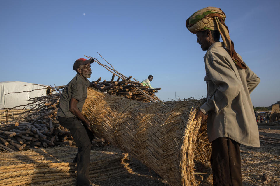 Tigray men who fled the conflict in Ethiopia's Tigray region, work to build shelters at Umm Rakouba refugee camp in Qadarif, eastern Sudan, Thursday, Nov. 26, 2020. Ethiopia's prime minister said Thursday the army has been ordered to move on the embattled Tigray regional capital after his 72-hour ultimatum ended for Tigray leaders to surrender, and he warned the city's half-million residents to stay indoors and disarm. (AP Photo/Nariman El-Mofty)