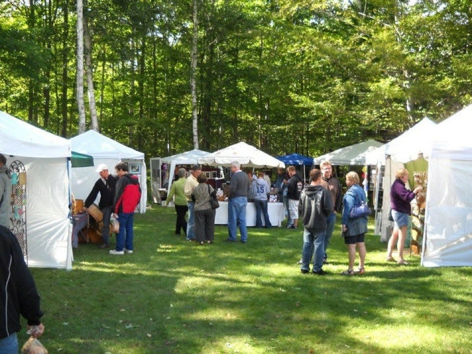 Art buffs gather outside Gills Rock Coffee for the annual Gills Rock ArtFest, which annually brings about 15 artists to Northern Door County over the Labor Day weekend to show their work and give demonstrations