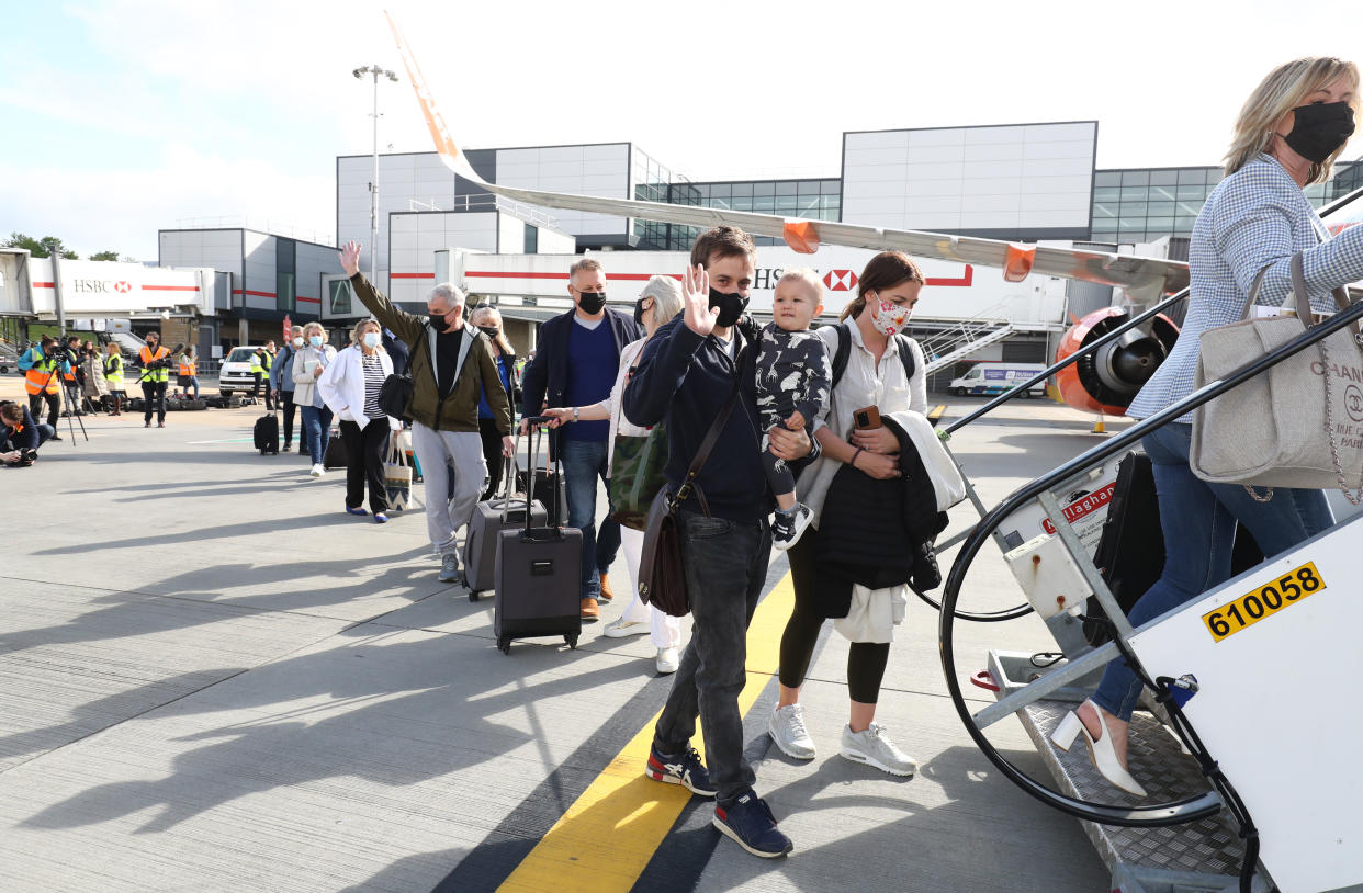 Passengers prepare to board an easyJet flight to Faro, Portugal, at Gatwick Airport in West Sussex after the ban on international leisure travel for people in England was lifted following the further easing of lockdown restrictions. Picture date: Monday May 17, 2021. (Photo by Gareth Fuller/PA Images via Getty Images)