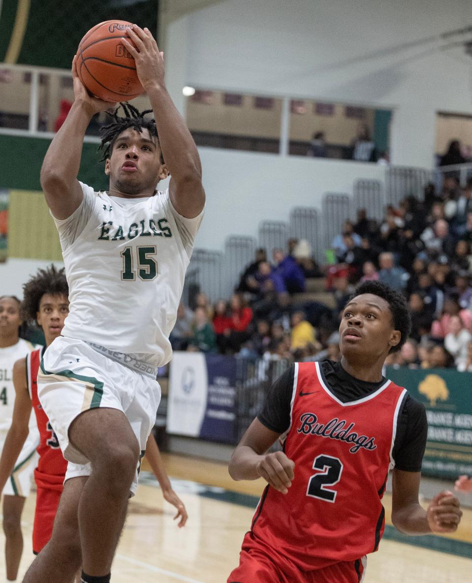 McKinley takes on GlenOak's Lisbon James (15) takes a shot as McKinley's Anthony Chavers (2) trails at GlenOak on Thursday, December 14, 2023.