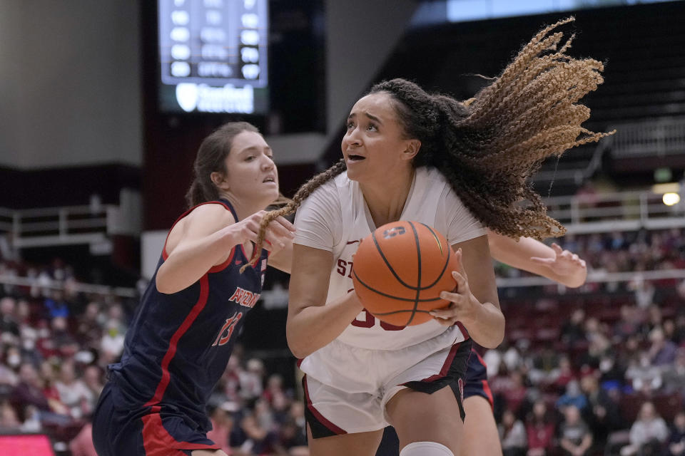 Stanford guard Haley Jones, right, looks to shoot against Arizona guard Helena Pueyo (13) during the second half of an NCAA college basketball game Monday, Jan. 2, 2023, in Stanford, Calif. (AP Photo/Tony Avelar)